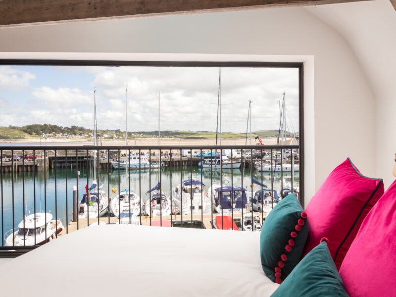 The master bedroom at The Grain Store overlooks Padstow Harbour.