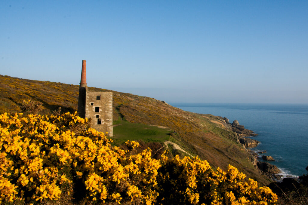 The Wheal Prosper engine house perched on cliffs at Rinsey Head near Porthleven, Cornwall