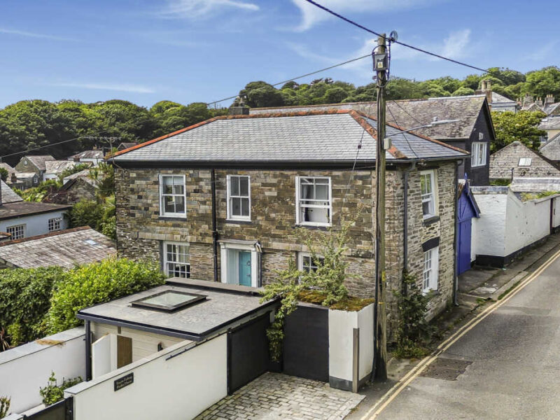 Charming Cornish seaside village with traditional stone cottages and scenic views.