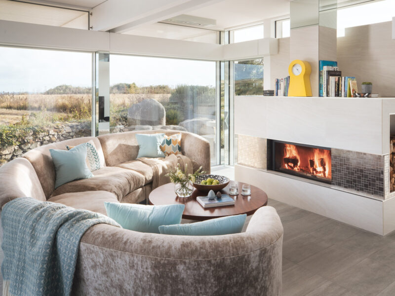 Living view across sofa to lit fire SE