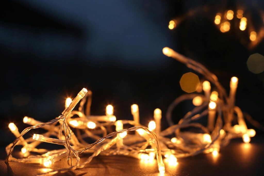 Warm white fairy lights glowing in the dark, creating a cosy and festive atmosphere.