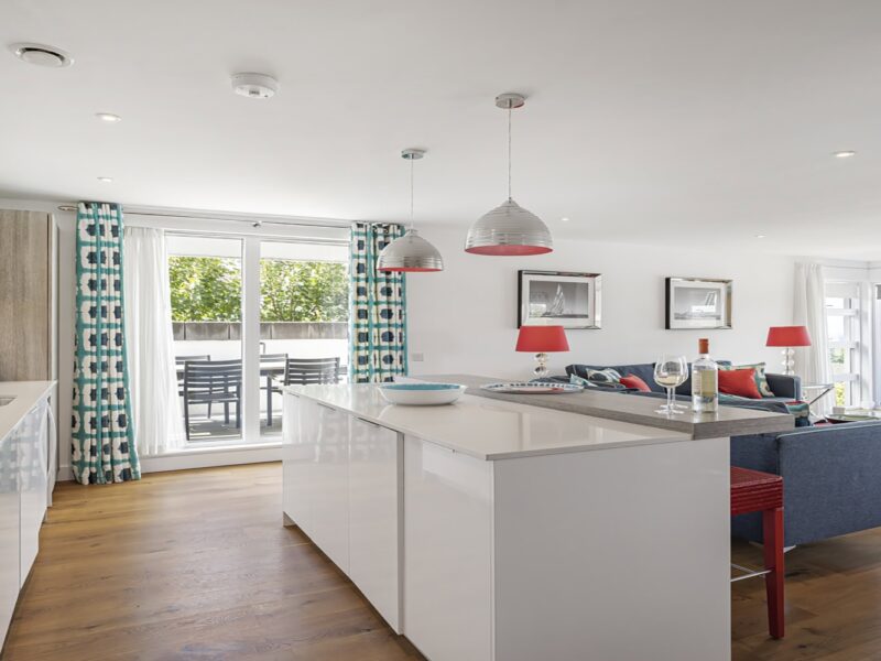 Modern coastal apartment living room with sea views and stylish decor.