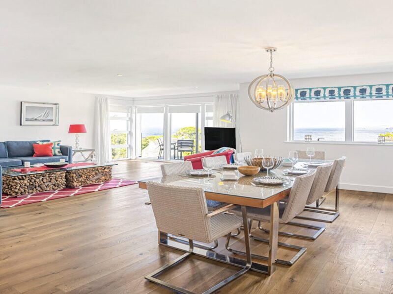 Spacious living and dining area with seaside views at Cornish Secrets holiday home in Cornwall.