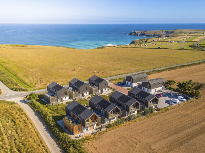 Aerial view of modern coastal cottages near the Cornish coast.