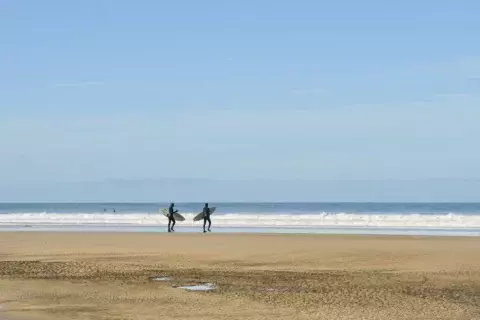 Surfers headed for the waves at Chapel Porth, Cornwall ©National Trust Images Hilary Daniel