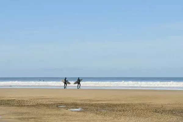 Surfers headed for the waves at Chapel Porth, Cornwall ©National Trust Images Hilary Daniel
