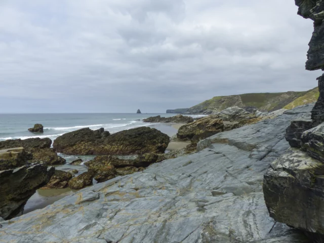 Distant view of Gull Rock at Trebarwith Strand in Port Isaac Bay, North Cornwall.