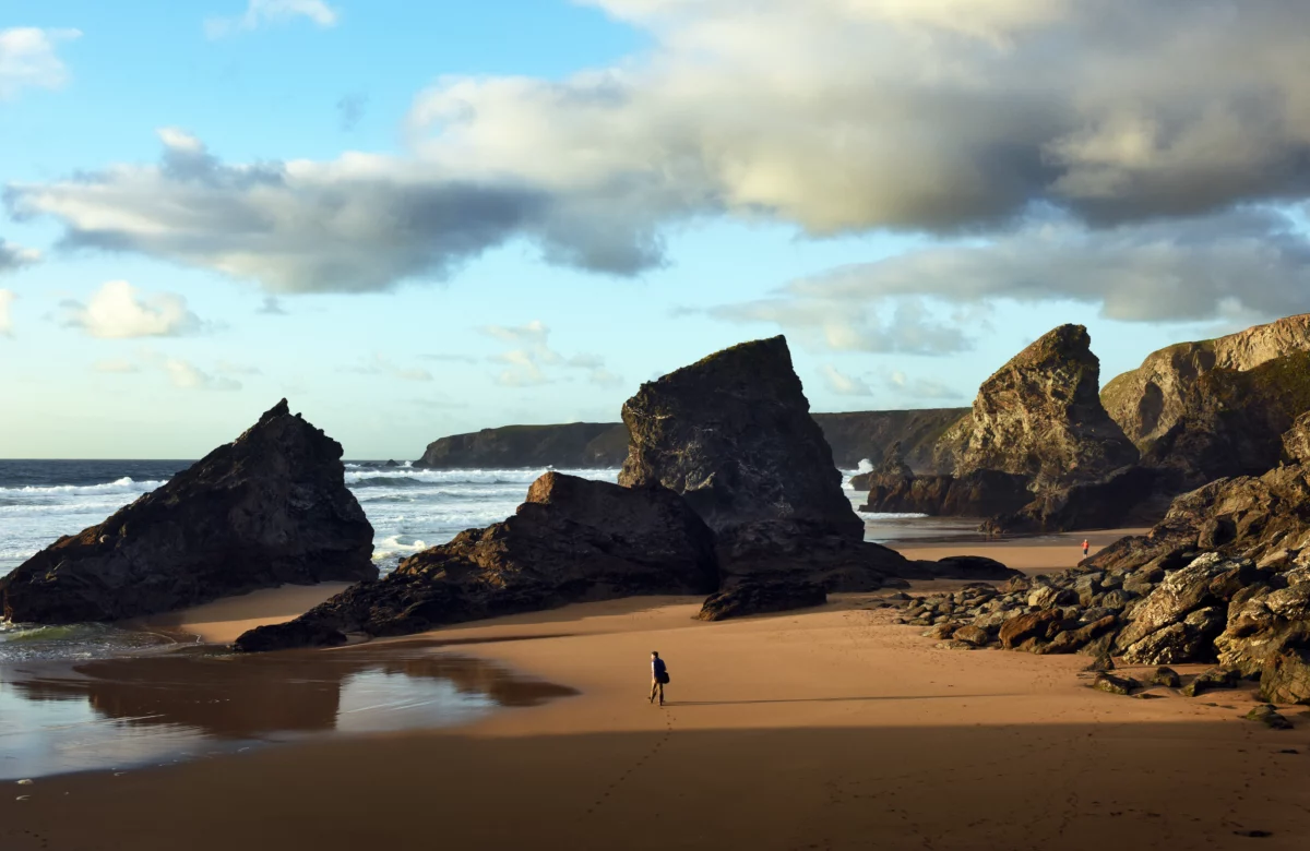 A walker on the beach at Carnewas at Bedruthan, Cornwall