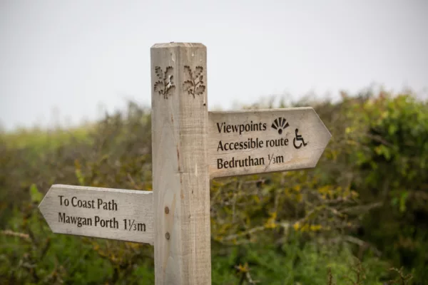 Wooden signpost on the coastal path at Carnewas at Bedruthan, Cornwall